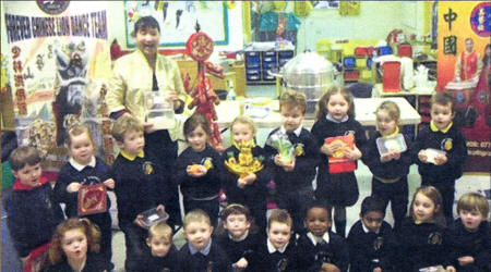 Holy Trinity Nursery School pupils get some lessons in Chinese cookery from Mei Lui.