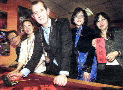Lisburn Deputy Mayor Edwin Poots practising some Chinese writing with Stanley Chan, Elaine Wong, Tracey Chan and Shirley Yu at the Chinese New Year Celebrations at Lisburn YMCA. US0509-119A0 Picture By: Aidan O'Reilly