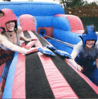 Hannah Bowden and Polly Black competing on the inflatable assault course on their last day at Wallace High School. US2109-105A0