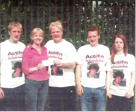 Aubrey Penney with sons Dwayne and Warren and daughter Alana present a cheque for £500 to Nicki Ingram of Upfront Breast Cancer Support Unit based at Lagan Valley Hospital which was raised by running the 10k race and fun run in Lisburn recently in memory of his late wife Margaret.