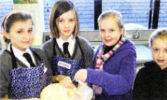 Pupils Anna McNeilly and Rebecca Hawkins showing their baking skills to sisters Jessica and Charlotte Forbes from Moira Primary. 