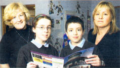 P7 school reporters Emma Rutter and Thomas Storey, who help to produce the new mouthy magazine at Ballycarrickmaddy Primary School. Included are Alison McGaughey and Hazel Gilmore, parents who have children at the school and who help with the production and layout of the magazine. USO409-532cd