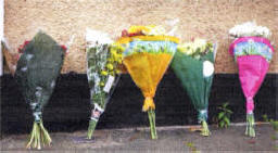 Floral tributes at Millbrook Road.