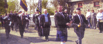 The parade of Old Comrades and Friends of the Somme Association led by the piper and bugler.