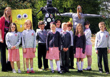 Teacher Debbie Lockhart and P5 pupils from Fort Hill lntegrated Primary with scarecrows they worked on together to design and create for the Hillsborough Garden Festival, which takes place from May 21-23. US2010-538cd