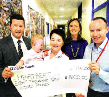 Gerard McAdorey, MD of GM Marketing with wife Maria and son Theo present 
	Alison Kearney and Dr Andrew Sands from the Clark Clinic in the RVH with 
	cheque for £8,100 for Heartbeat Nl.