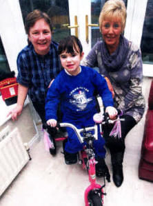 Heidi Joss on her bike with Mum Diane Joss and Margaret McCormick who took part in a sponsored walk from Belfast to Lisburn to help pay for the Bike. US0210-114A0
