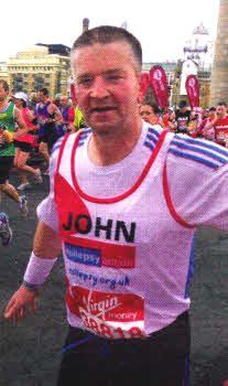 Hard at work John on London's Tower Bridge at the half way stage of the marathon.
	