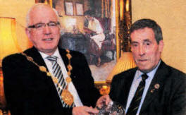 The Mayor, Councillor Allan Ewart, presents a gift to guest of honour Maurice Leathem in recognition of 56 years service to the Lisburn Branch of the Royal British Legion.