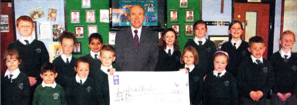 Mr McClean, Principal of St. Aloysius PS and his pupils proudly display the total amount of money rasied for the Lenten Charities.
	