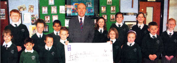 Mr McClean, Principal of St. Aloysius PS and his pupils proudly display the total amount of money rasied for the Lenten Charities.
	