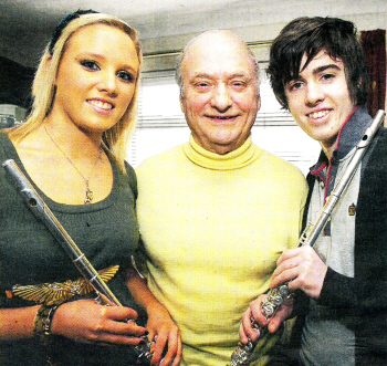 Music teacher Brian Houston with Maria McGrann and Reuben Hanna, who have both received Grade 8 awards from the Royal School of Music for playing the flute. US0610-509cd