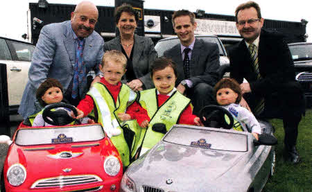 Two unique pedal cars fitted with seatbelts have been presented to the D0E's Road Safety Branch. 