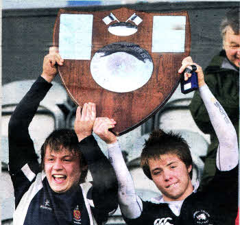 Wallace High School captain Zack McCall and Campbell College captain Rob Haldane lift the Northern Bank Medallion Shield after the final ended in a draw at Ravenhill.