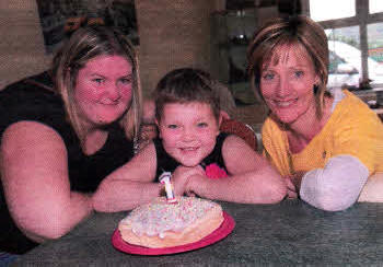 Julie-Anne Donnelly, Alannah Donnelly and family support worker Lynn Wilson enjoy a special cake celebrating the introduction of the support scheme by the Northern lreland Cancer Fund for Children.
