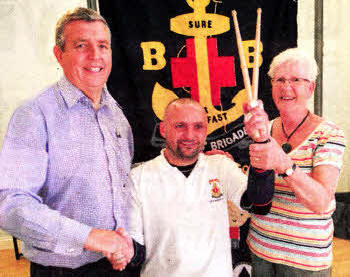 Allister is congratulated by his proud parents Nigel and Maureen after breaking the Guinness World Record for the longest individual drum roll.
	