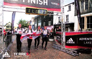The local team cross the finish line.