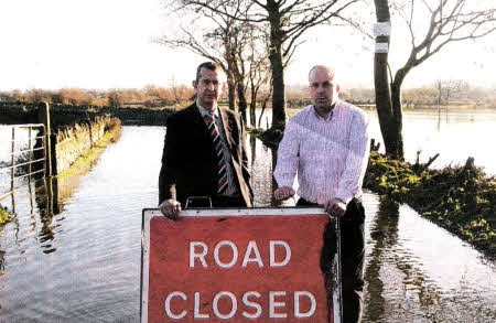 Lagan Valley MLA Edwin Poots with local Councillor James Tinsley at one of the roads in the Flatfield area which was closed last week due to floods.