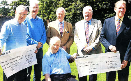 Jim Henry, Chairman of Parkinson UK Lisburn Branch, Stephen Anderson, Treasurer Parkinson UK Lisburn Branch, Colonel Richard Gordon, Chairman SSAFA Nl, Major David Keith, Treasurer SSAFA Nl, Lord Anthony Hamilton President SSAFA Nl receiving cheques of £5732.50 and £5000 respectively from Mr Ned Falloon CBE (Centre). US3010-109A0