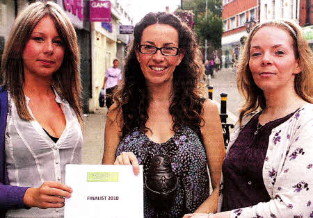 Wilson Country's Robyn McWhirter presents the `Good Spud' trophy and restaurant voucher to local winner Ceara Gallagher, alongside the Ulster Star's Stacey Heaney.