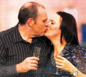Gillian Lyttle and Mark Allison share a romantic kiss after winning a 25K wedding package at the Wedding Journal Show.
