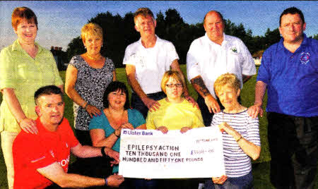 Derriaghy Cricket Club Chairman, John Agnew, Debbie Guy, Chair of the Seymour Hill Housing Association, Morina Clarke, Regional Secretary Epilepsy Action, Trevor Hayes, Valerie Smith, Adrian Donaldson Secretary of Derriaghy CC FC, with Denise and Sarah Hook and John Torrans with a cheque for Epilepsy Action. US2410-402PM