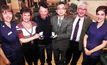 Valerie Miller Diabetes Specialist Nurse, Dr Kieran Walshe, Dr Simon Au Consultants in Diabetes Lagan Valley Hospital, lvan Crawford receiving 60 year medal, Dr Helen Whitehead Presenting medal and Hilda Francis Diabetes Specialist Nurse. US1510-118A0
