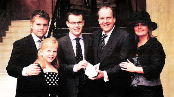 PROUD MOMENT...Peter, Catherine, Thomas and Mandy with John when he received his MBE.