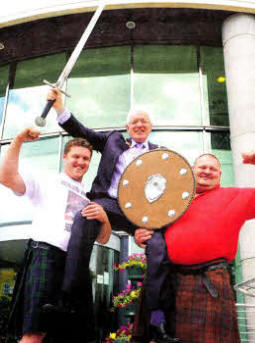 The Mayor of Lisburn, Councillor Allan Ewart is lifted by Glenn Ross and current Highland Games Champion Jonathan Kelly at the launch of the Lisburn Highland Games. The Highland Games are taking place at Lagan Valley LeisurePlex on Saturday 26 June from 12 noon to 6pm.