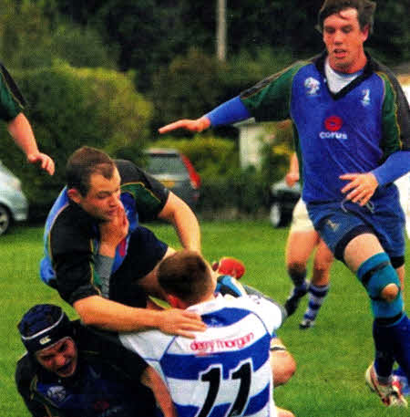 Lisburn's Adam Melville and Andrew Gibb ensures this Dungannon player doesn't go anywhere. Photo by Tom Porter Photography.