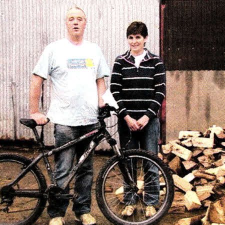 Alan Hunter delivering logs to Lynda Steele of Crumlin as part of her prize for entering a competition in aid of Marie Curie Cancer Care.