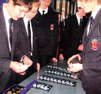 Pupils from Young Enterprise at Wallace High School selling Mark Wells' album to pupils in the school.