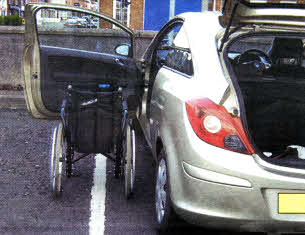 The disabled parking bay in the Antrim Street Car Park. A car with its doors fully extended encroaches on the spaces next to it.