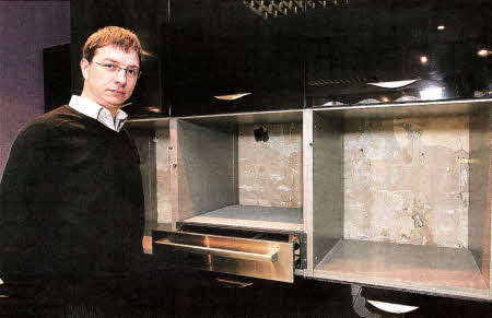 Phillip Cardy, from Richardson Cardy stands beside one of the empty kitchen units in the shop after thieves broke in at the weekend and stole a number of ovens and other electrical appliances. US4210-522cd