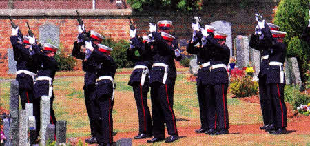 A firing party fire rounds into the air at the graveside
	