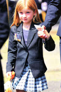 Corporal Stephen Walker's young daughter Greer proudly wears her daddy's medals at the funeral of the Lisburn soldier who was killed in Afghanistan last month.