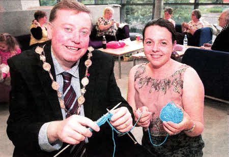Mayor Paul Porter gets some knitting tips from Lorraine Yarr, from the 'Stitch 'n Bitch' group, when he called at their weekly session at Lisburn library. US311O-527cd