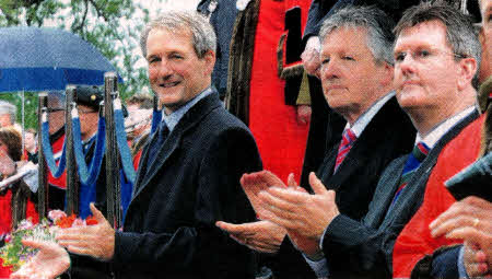 Secretary of State Owen Paterson, First Minister Peter Robinson and Lagan Valley MP Jeffrey Donaldson applaud as the parade gets underway.