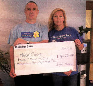 Allyson presenting Phil Kane of Marle Curle Cancer Care, Belfast with the money raised for her Kllimanjaro trek