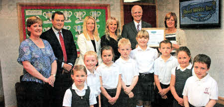 Mrs Gill Clement from Oxford University Press presents Principal Mr Derek Capper with a certiflcate conferring Model School status upon Anahilt Primary on behalf of 0UP and Ruth Miskin Literacy.