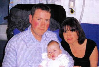 Carolyn Houston and her husband with baby Ella.