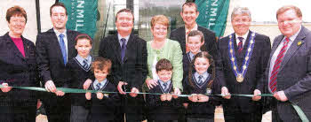 From left are Joan Baird, Chair of Clanmil Housing Association who own and manage the scheme, Paul Given MLA, Nadia and Zino Zerai, pupils at the neighbouring St Joseph's Primary School, Will Haire, Permanent Secretary of the Department for Social Development, Mrs. Maureen Ferris, a tenant at the scheme, with her grandchildren Peter, Annie and Olivia Kennedy, Edwin Poots MLA, Councillor Brian Heading, Deputy Mayor of Lisburn, and Jonathan Craig MLA.