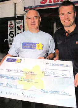 Colin Watterson handing over a cheque for £2068 to Phil Kane community Fundraising Manager of Marie Curie Cancer Care. US3611-108A0