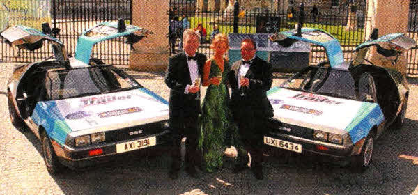 (L-R) Robert Lamrock, a Director of the DeLorean Owners Association, joins Sophie Jenkins Anderson and Lottery winner and member of the DeLorean Owners Association, Peter Lavery, to celebrate the 30th Anniversary of the first DeLorean rolling off the production line and into the history books.
