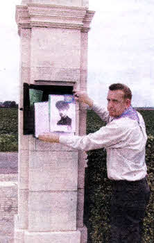 John Hilland, Scout Leader, 1st Derriaghy, places details of Lt. E. Brown and 1st Derriaghy in the memorial box at the gateway of The Huts