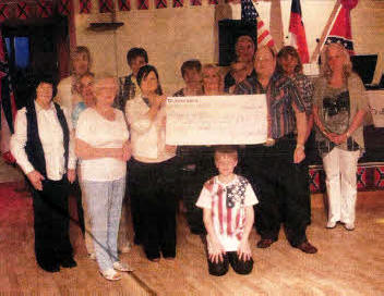 Cajun Critters Music Club presents a cheque to representatives for Diabetes UK.