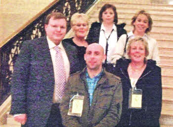 Anne Blake, Lisburn Carers Forum and Jonathan Craig with the family of the late lvy McCluskey, at Stormont following a meeting with the First Minister.