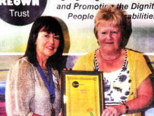 Trust President Kate Smith presents Andrea McCormick with her Carers Certificate.