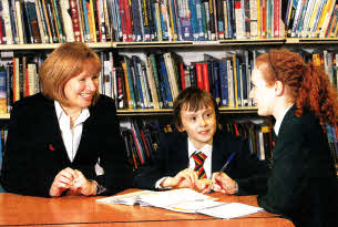 Year 8 pupil Joshua Spratt with his Year 14 Mentor, Caroline Wilkinson, and Principal Elizabeth Dickson