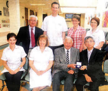 George Johnston receiving his Lawrence Medal from the Diabetic team at the Lagan Valley Hospital. US2211-109A0